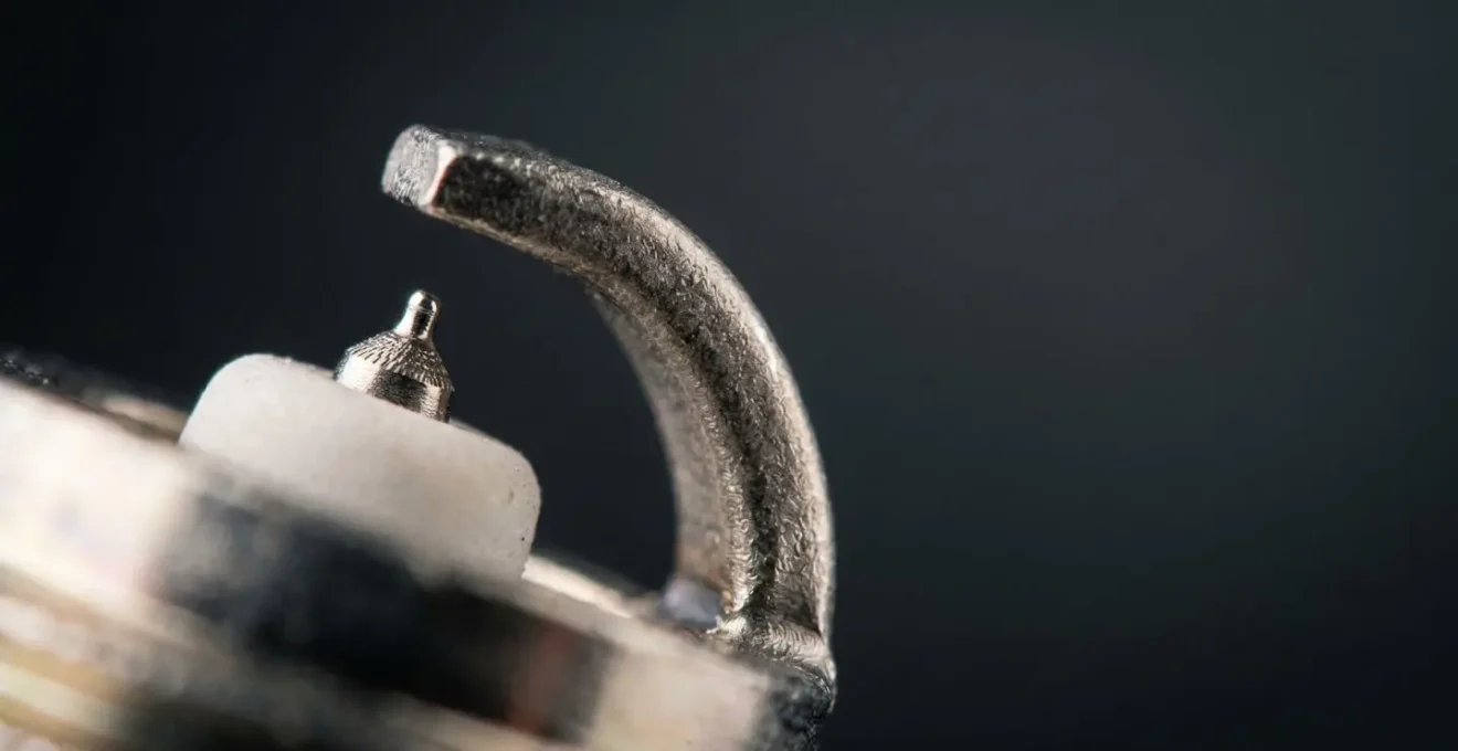 Macro detail of iridium spark plug electrode showing fine-wire tip design
