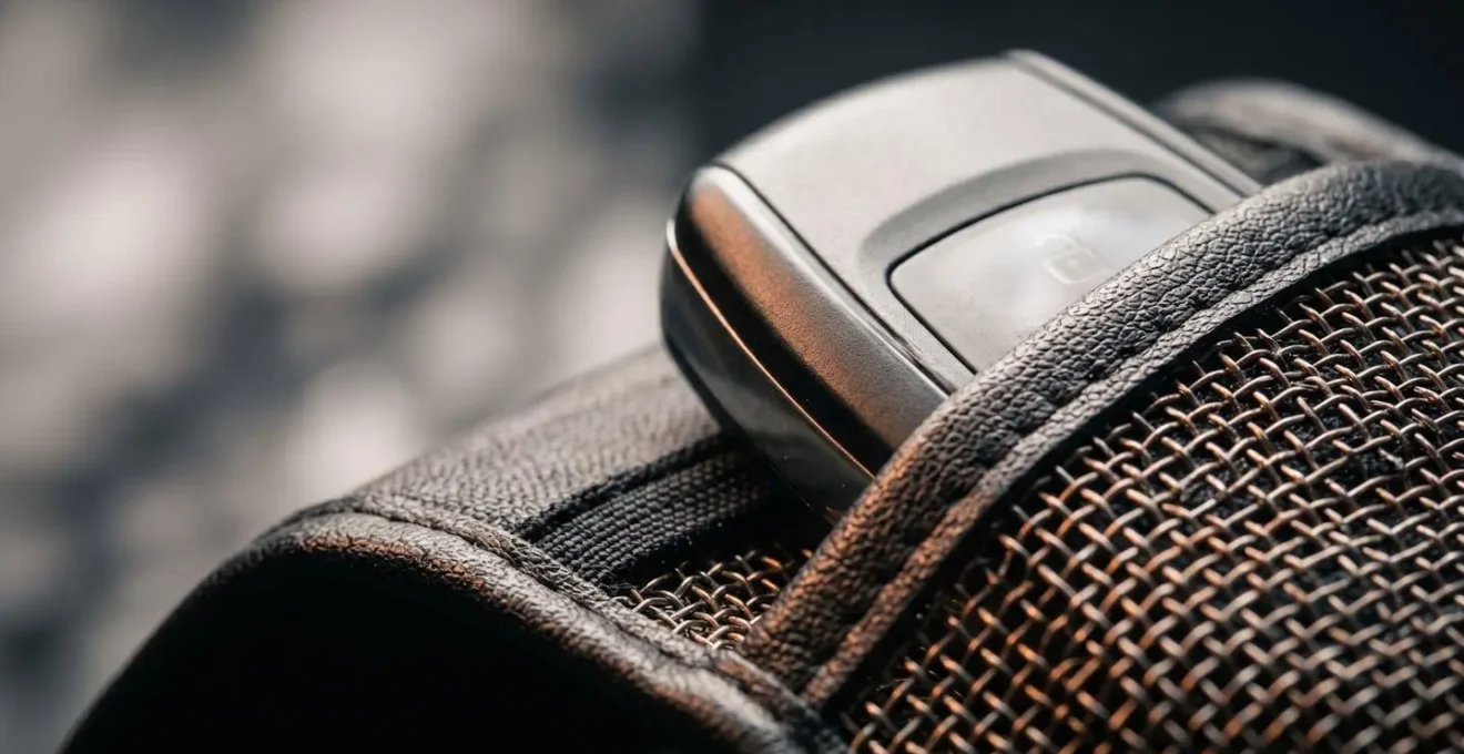 Macro detail of keyless car fob secured in signal-blocking Faraday protective case showing security layering