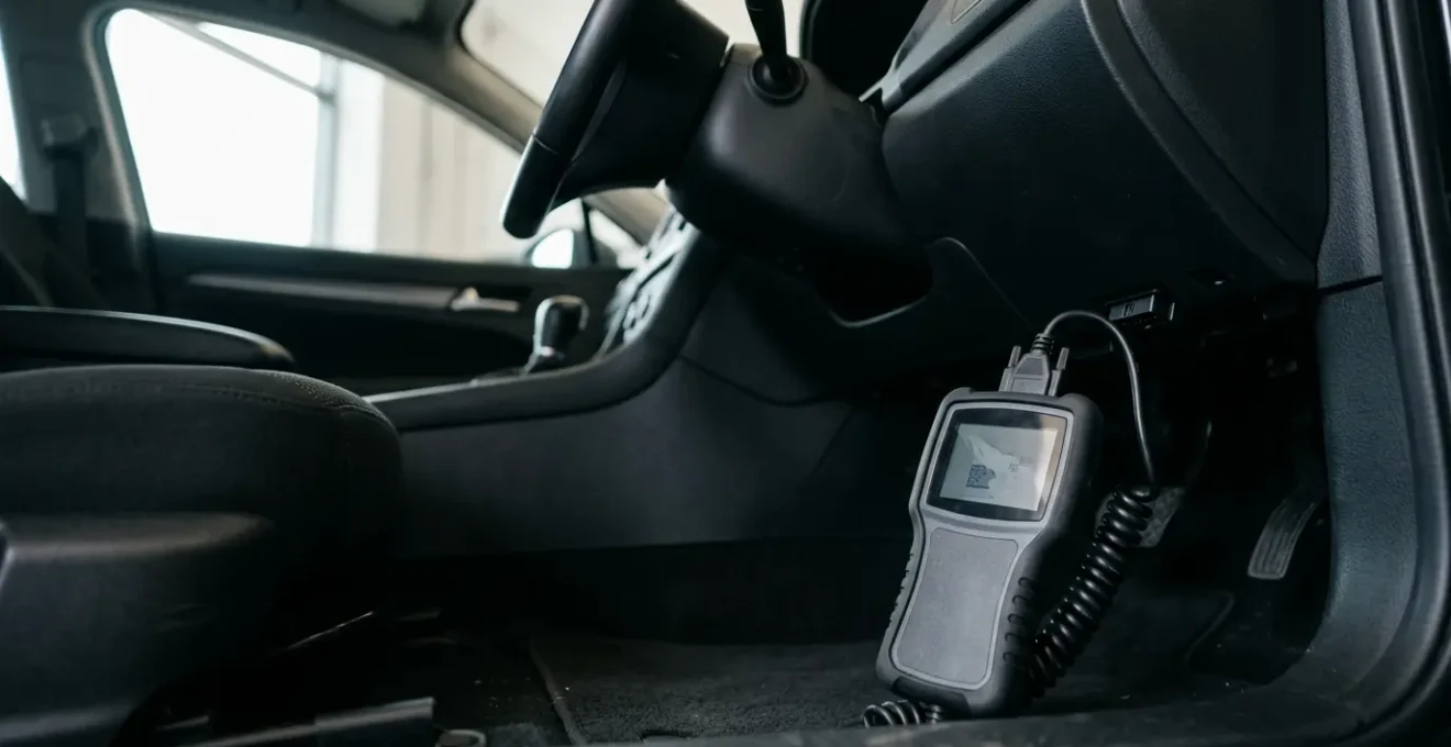 Professional automotive diagnostic scene with OBD2 scanner device connected to vehicle diagnostic port