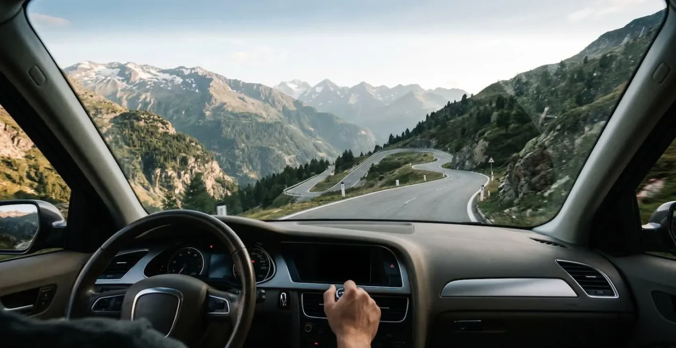 Driver's perspective showing manual gear selection on steep mountain incline with dramatic landscape